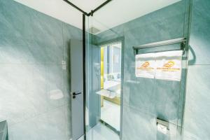 a bathroom with a shower with a glass door at Tan Son Nhat Airport - Golden Sun Hotel in Ho Chi Minh City