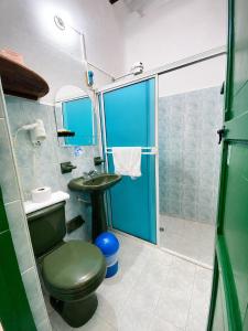 a bathroom with a green toilet and a sink at Posada Sueños de Antonio in Barichara +58 photos