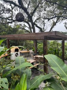 a wooden pavilion with a pizza oven in a garden at Casa Xunaan in Gómez Farías