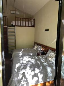 a bedroom with a bed and a bunk bed at Casa Xunaan in Gómez Farías