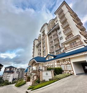 a large apartment building with a sign in front of it at Boho-Nordic Studio at Twin Lakes Vineyard, Tagaytay by Cozy Escape in Laurel