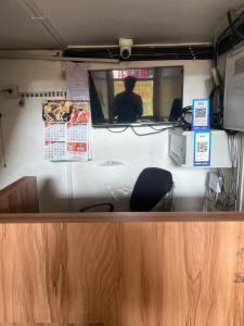 a food truck with a person sitting in the window at morriz inn in Kalpetta
