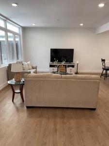 a living room with a couch and a flat screen tv at Coral Sands in Seaside Heights