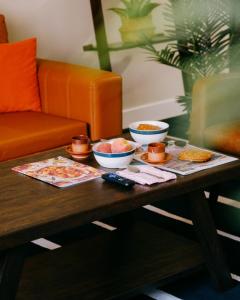 a coffee table with bowls of food on it at Modern Condo • Safe Chicago Stay Near O’Hare in Chicago