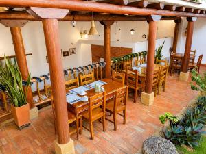 a dining room with wooden tables and chairs at Posada Sueños de Antonio in Barichara