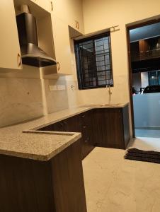 a kitchen with a sink and a stove top oven at Md Couple Stay in Covelong