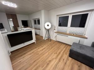a living room with a large flat screen tv at bei gitta in Olpe