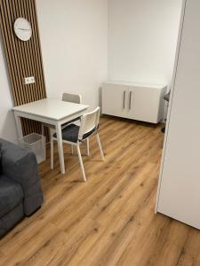 a white table and chairs in a room with a floor at bei gitta in Olpe
