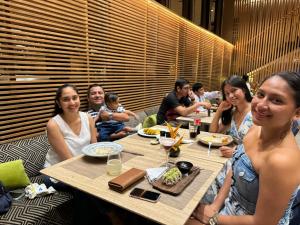 a group of people sitting at a table in a restaurant at Sonrisas in Iquitos