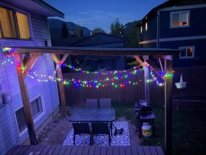 a patio with a string of lights and a table at Supinder's Rentals in Golden