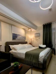 a hotel room with a bed and a couch at The View at 34th - Sunset Skyline Suite Near SM J Mall & Fiber Wifi in Mandaue City +21 photos