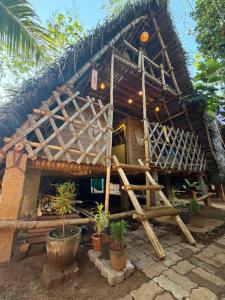 a house with plants in front of it at v kudil in Auroville