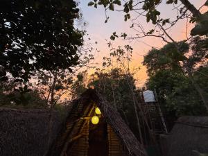 a house with a light on top of it at v kudil in Auroville