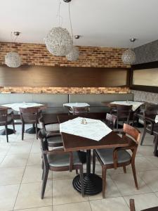 a restaurant dining room with tables and chairs at Hotel Velky Meder in Veľký Meder