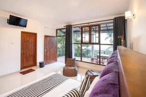 a living room with a couch and a large window at Ella Ostella in Ella