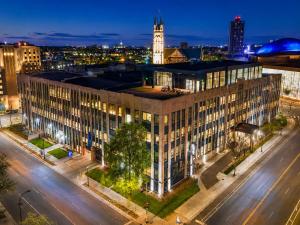 a large building on a city street at night at Roami at Century Plaza in Minneapolis