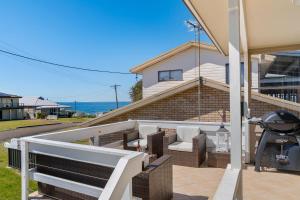 a patio with chairs and a grill in front of a house at Oceans 13 in Manyana