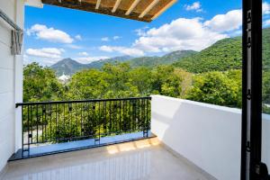 a balcony with a view of mountains at COBI’s Home in Cam Lâm