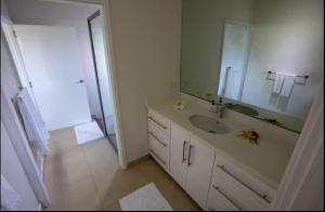 a bathroom with a sink and a large mirror at Raitotoka Eco Resort in Matei +3 photos