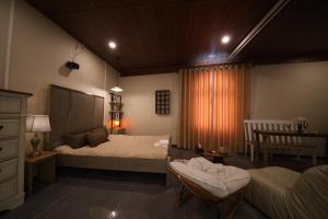 a bedroom with two beds and a table and a chair at Àla Homestay Cần Thơ in Can Tho