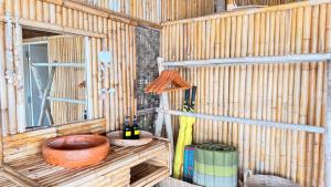 a wooden shed with a window and bottles of wine at Deep House Sea View in Ko Lanta