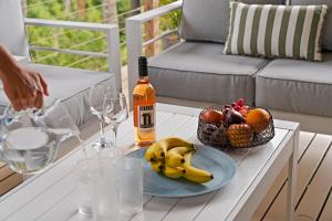 a bottle of wine and a basket of fruit on a table at Simmons Sanctuary Ulladulla in Ulladulla