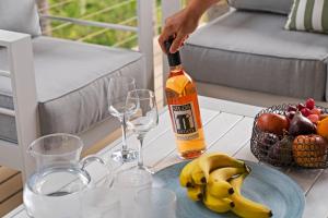 a person is pouring wine into glasses on a table at Simmons Sanctuary Ulladulla in Ulladulla +22 photos