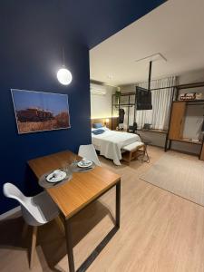 a living room with a bed and a table and a room with a couch at Hotel In Loft Elleva Studio in Sinop