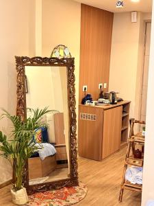 a mirror in a living room with a kitchen at Greno luxe stays in Greater Noida
