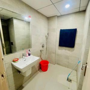 a bathroom with a sink and a mirror at Greno luxe stays in Greater Noida