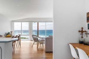 a kitchen and dining room with a view of the ocean at Ocean Overlook - Rennies Beach holiday haven in Ulladulla +36 photos
