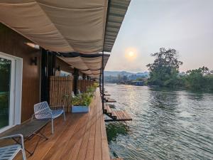 a building with a deck with a view of a river at Rivendale in Ban Gaeng Cho