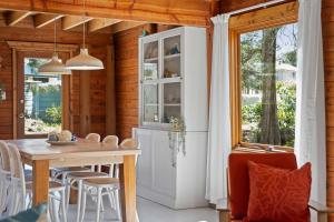 a dining room with a table and a window at The Beach Haven in Bawley Point