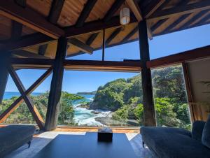 a room with a view of the ocean from a house at The Villa Kotoshiro -ヴィラ コトシロ- in Matsue