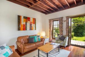 a living room with a couch and a table at Stone Cottage - vineyard estate w. fireplace in Milton