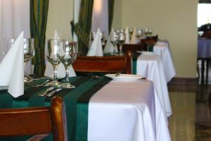 a group of tables with wine glasses on them at Grand Hotel Gozo in Għajnsielem