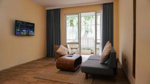 a living room with a couch and a chair at The Rivavi Legian in Legian