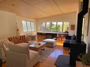 a living room with a couch and a table at Murramarang Haven in Bawley Point