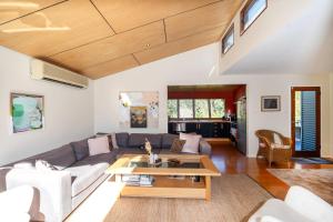 a living room with a couch and a table at Murramarang Haven in Bawley Point