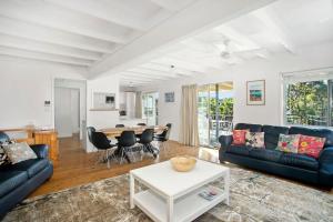 a living room with a couch and a table at MeNo's at Bawley in Bawley Point