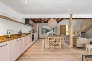 a kitchen and dining room with a table and chairs at Coastal Soul in Narrawallee