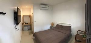 a bedroom with a bed in a white room at Homestay Laksi in Lak Si +7 photos