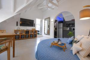 a large living room with a blue bed and a table at Deja Blue - Comfortable Beachfront condo in Marigot