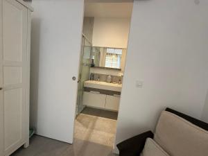 a bathroom with a sink and a couch in a room at Studio en maison historique in Golfe-Juan +6 photos