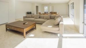 a living room with a couch and a coffee table at Anchor at Bawley in Bawley Point