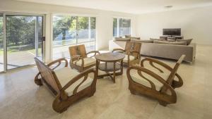 a living room with chairs and a table and a couch at Anchor at Bawley in Bawley Point
