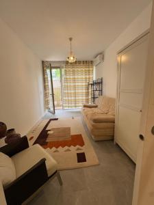 a living room with a couch and a table at Studio en maison historique in Golfe-Juan
