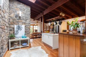 a kitchen with a stone wall and a counter at Banyula in Bawley in Bawley Point