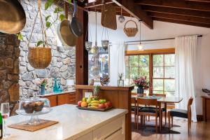 a kitchen with a table with a bowl of fruit at Banyula in Bawley in Bawley Point