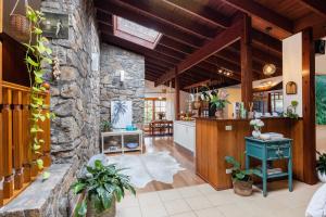 a kitchen and living room with a stone wall at Banyula in Bawley in Bawley Point